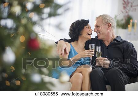 Stock Photography - Happy mature couple on christmas time. Fotosearch