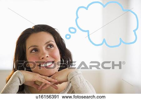Stock Image - Happy young woman daydreaming. Fotosearch