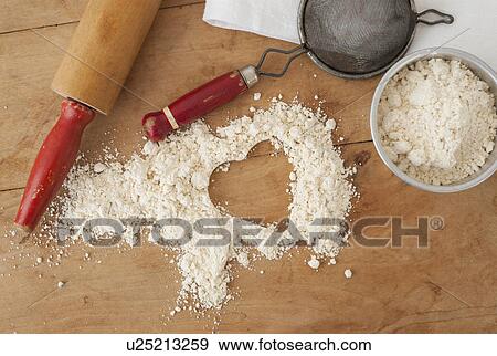 Heart shape in flour with baking utensils View Large Photo Image Stock Photo - Heart shape in flour with baking utensils. Fotosearch