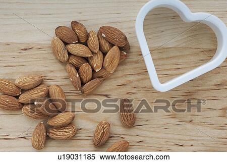 Heart shaped almonds with cutter on chopping board View Large Photo Image Stock Photography - Heart shaped almonds with cutter on chopping board. Fotosearch