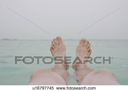 Stock Photography - Israel, Dead Sea, mature men's legs in sea. Fotosearch