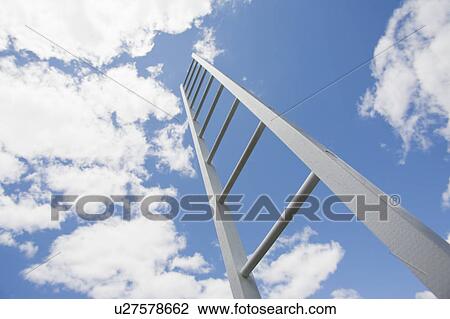 Stock Image - Ladder reaching cloudy sky. Fotosearch