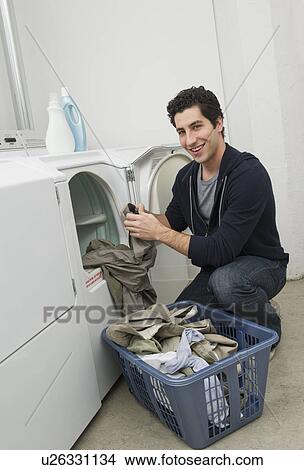 Man doing laundry View Large Photo Image Picture - Man doing laundry. Fotosearch