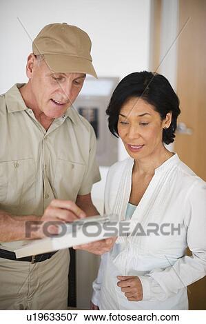 Mature woman talking to technician View Large Photo Image Stock Photo - Mature woman talking to technician. Fotosearch