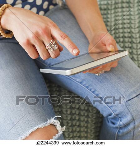 Midsection of woman using digital tablet View Large Photo Image Stock Photo - Midsection of woman using digital tablet. Fotosearch