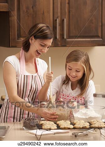 Mother baking with daughter (10-11) in kitchen View Large Photo Image Stock Image - Mother baking with daughter (10-11) in kitchen. Fotosearch