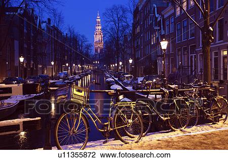 Stock Image - Netherlands, Amsterdam, Bicycles on bridge over canal. Fotosearch