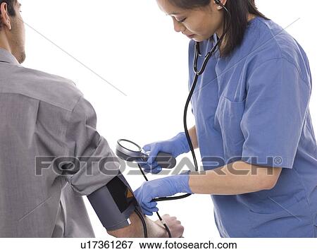 Nurse checking patients blood pressure View Large Photo Image Stock Photo - Nurse checking patients blood pressure. Fotosearch