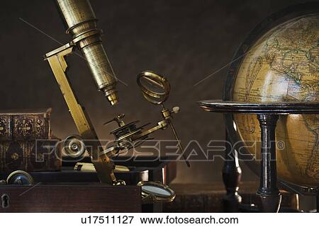 Stock Photo - Old microscope and globe. Fotosearch