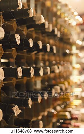Stock Photo - Old wine bottles on cellar shelves. Fotosearch