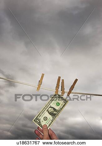 Stock Photo - One dollar banknote drying on clothline. Fotosearch