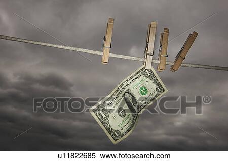 Stock Photography - One dollar banknote drying on clothline. Fotosearch