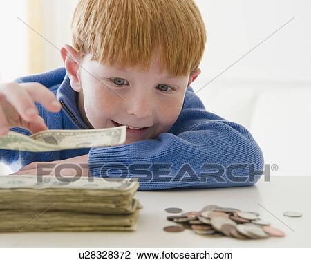 Portrait of boy (8-9) counting money View Large Photo Image Stock Image - Portrait of boy (8-9) counting money. Fotosearch