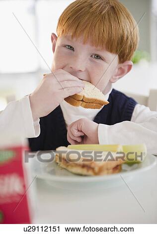 Portrait of boy (8-9) eating sandwich View Large Photo Image Stock Image - Portrait of boy (8-9) eating sandwich. Fotosearch