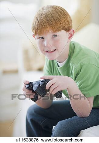 Portrait of boy (8-9) playing video game View Large Photo Image Stock Photograph - Portrait of boy (8-9) playing video game. Fotosearch