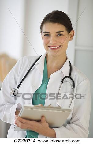 Picture - Portrait of cheerful female doctor. Fotosearch