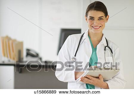 Stock Photo - Portrait of cheerful female doctor. Fotosearch