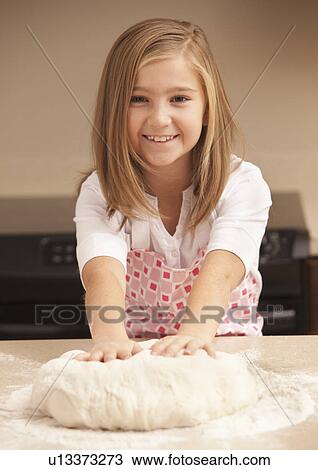Portrait of girl (10-11) kneading dough in kitchen View Large Photo Image Stock Image - Portrait of girl (10-11) kneading dough in kitchen. Fotosearch