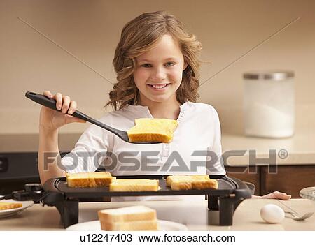 Portrait of girl (10-11) preparing toast in kitchen View Large Photo Image Stock Image - Portrait of girl (10-11) preparing toast in kitchen. Fotosearch