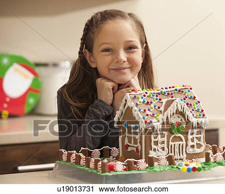 Portrait of girl (6-7) by gingerbread house View Large Photo Image Stock Image - Portrait of girl (6-7) by gingerbread house. Fotosearch