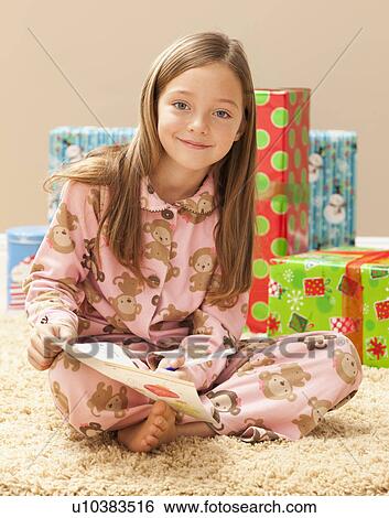 Portrait of girl (6-7) preparing Christmas presents View Large Photo Image Stock Photograph - Portrait of girl (6-7) preparing Christmas presents. Fotosearch