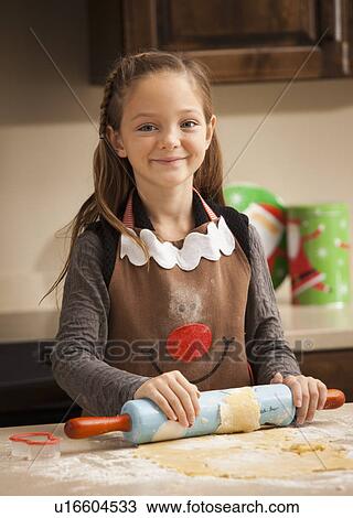 Portrait of girl (6-7) rolling dough View Large Photo Image Stock Image - Portrait of girl (6-7) rolling dough. Fotosearch