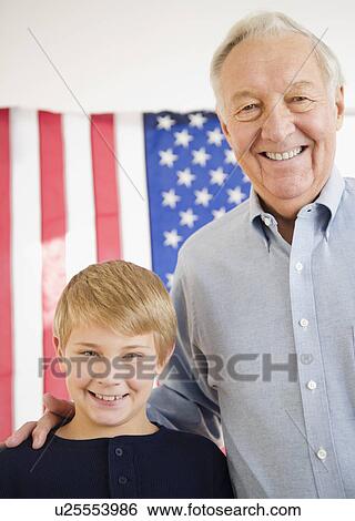 Portrait of grandfather with grandson (8-9) with American flag View Large Photo Image Stock Photograph - Portrait of grandfather with grandson (8-9) with American flag. Fotosearch