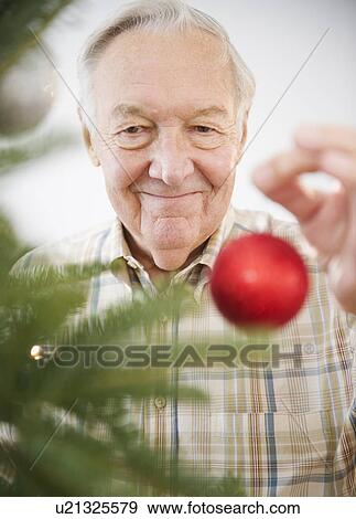 Portrait of senior man decorating Christmas tree View Large Photo Image Stock Photo - Portrait of senior man decorating Christmas tree. Fotosearch