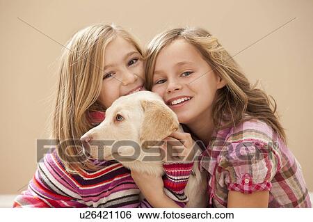 Portrait of two girls (10-11) embracing Labrador View Large Photo Image Stock Photograph - Portrait of two girls (10-11) embracing Labrador . Fotosearch
