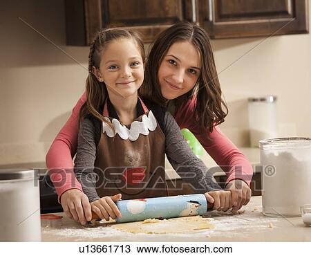 Portrait of two sisters (6-7, 18-19) rolling dough View Large Photo Image Stock Image - Portrait of two sisters (6-7, 18-19) rolling dough. Fotosearch