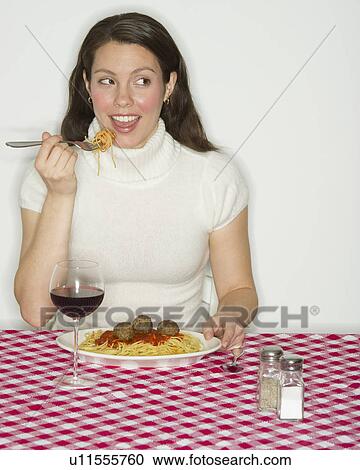 Portrait of woman eating spaghetti with meatballs View Large Photo Image Stock Image - Portrait of woman eating spaghetti with meatballs. Fotosearch