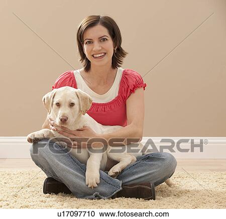 Portrait of woman embracing Labrador on carpet View Large Photo Image Stock Image - Portrait of woman embracing Labrador on carpet. Fotosearch