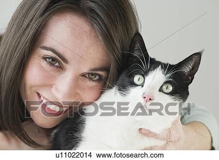 Portrait of woman hugging cat View Large Photo Image Picture - Portrait of woman hugging cat. Fotosearch