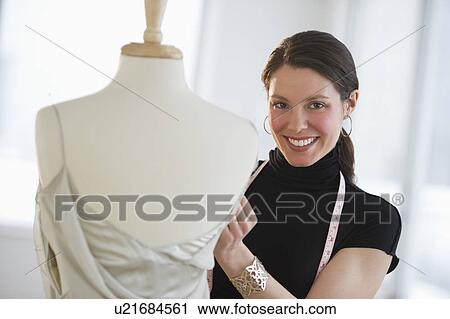 Portrait of young fashion designer at work View Large Photo Image Stock Image - Portrait of young fashion designer at work. Fotosearch
