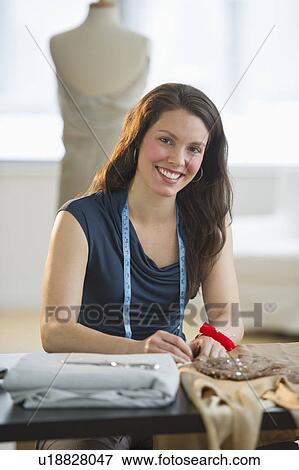 Portrait of young fashion designer at work View Large Photo Image Stock Photo - Portrait of young fashion designer at work. Fotosearch