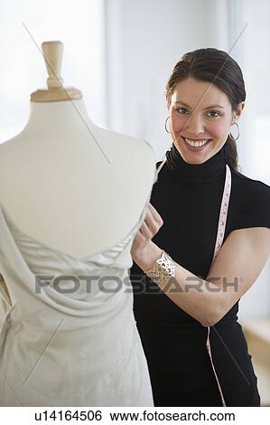 Portrait of young fashion designer at work View Large Photo Image Stock Photograph - Portrait of young fashion designer at work. Fotosearch
