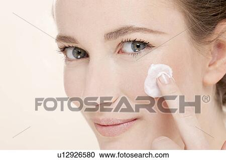 Portrait of young woman holding cotton pad View Large Photo Image Stock Image - Portrait of young woman holding cotton pad. Fotosearch