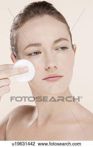 Portrait of young woman holding cotton pad View Large Photo Image Stock Image - Portrait of young woman holding cotton pad. Fotosearch