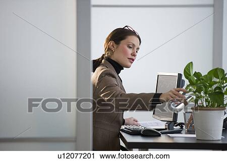 Portrait of young woman in office View Large Photo Image Stock Image - Portrait of young woman in office. Fotosearch