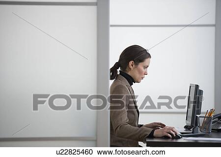 Portrait of young woman in office View Large Photo Image Stock Image - Portrait of young woman in office. Fotosearch