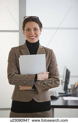 Portrait of young woman in office View Large Photo Image Stock Photo - Portrait of young woman in office. Fotosearch