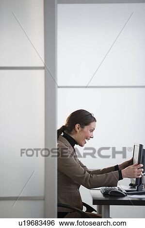Portrait of young woman in office View Large Photo Image Stock Photograph - Portrait of young woman in office. Fotosearch