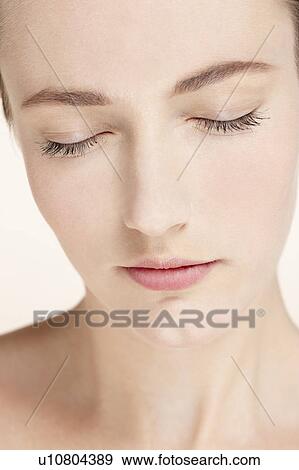 Stock Photo - Portrait of young woman with eyes closed. Fotosearch