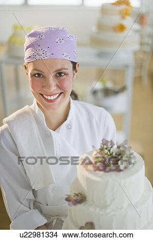 Portrait of young woman with wedding cake View Large Photo Image Picture - Portrait of young woman with wedding cake. Fotosearch