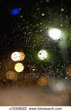 Stock Image - Rain drops on car window. Fotosearch