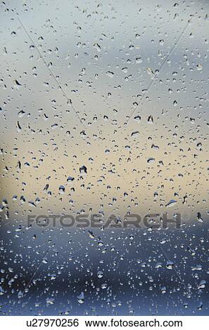 Rain drops on window View Large Photo Image Stock Photograph - Rain drops on window. Fotosearch