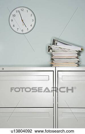 Stack of documents on filing cabinet View Large Photo Image Stock Image - Stack of documents on filing cabinet. Fotosearch