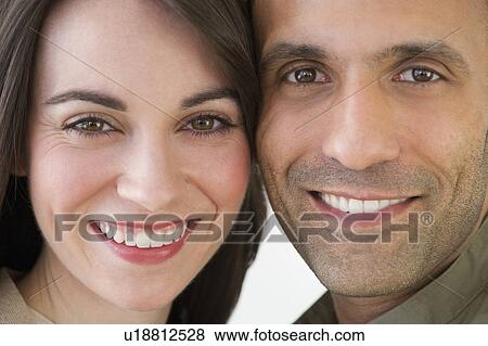 Stock Photo - Studio portrait of couple smiling. Fotosearch