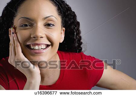 Studio portrait of young woman smiling View Large Photo Image Stock Photo - Studio portrait of young woman smiling. Fotosearch