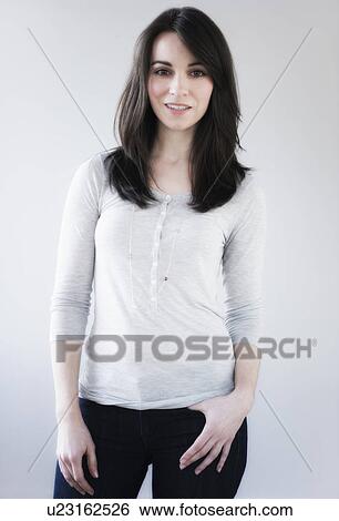 Stock Photograph - Studio portrait of young woman smiling. Fotosearch